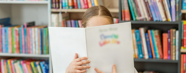 Enfant lisant dans un espace jeunesse en médiathèque